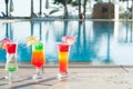 Colored cocktails on a background of water. Royalty Free Stock Photo