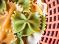 Colored cooked farfalle pasts closeup