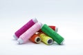 Sewing supplies - colored threads. Colored cotton threads on a white background. Royalty Free Stock Photo