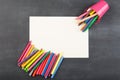 colored crayons and blank page on the blackboard Royalty Free Stock Photo