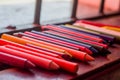 colored crayons, various colors of crayons on a wooden table with natural light and background window, diversity Royalty Free Stock Photo