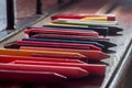 colored crayons, various colors of crayons on a wooden table with natural light and background window, diversity Royalty Free Stock Photo