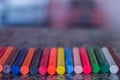 colored crayons, various colors of crayons on a wooden table with natural light and background window, diversity Royalty Free Stock Photo