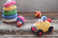 Colored crochet racing car and pyramid from colored rings. Toy for babies and toddlers to learn mechanical skills and colors. Royalty Free Stock Photo