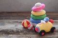 Colored crochet racing car and pyramid from colored rings. Toy for babies and toddlers to learn mechanical skills and colors. Royalty Free Stock Photo