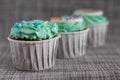 Colored cupcakes close-up on grey fabric background Royalty Free Stock Photo