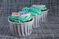 Colored cupcakes close-up on grey fabric background Royalty Free Stock Photo