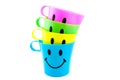 Colored cups with happy face Royalty Free Stock Photo