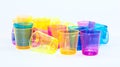 Colored cups on a white background - yellow, orange, pink and blue Royalty Free Stock Photo