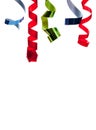 Colored curly ribbon in front of white Royalty Free Stock Photo