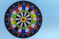 Colored dartboard, on a blue background foreground. Darts without darts. Successful strategy concept