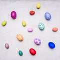 Colored decorative easter eggs white wooden background top view close up