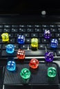 Colored dices on keyboard - on line gambling concept