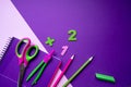 Colored different school supplies on lilac paper background. Back to school concept. Flat lay, copy space Royalty Free Stock Photo