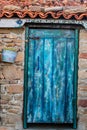 Colored Door, with brick roof and flower pot Royalty Free Stock Photo