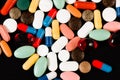 Colored drugs in capsules on a black background Royalty Free Stock Photo