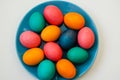 Colored easter eggs on a blue plate on a white background Royalty Free Stock Photo