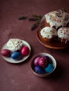 Colored Easter eggs, cakes on dark purple background Royalty Free Stock Photo