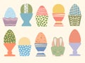 Colored Easter eggs in cute cups vector illustration set. Eggs decorated with brush strokes and dots on pastel Royalty Free Stock Photo