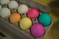 Colored Easter eggs in egg carton for easter egg hunt Royalty Free Stock Photo