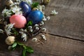 Colored Easter eggs in a nest with willow branches and spring flowers Royalty Free Stock Photo