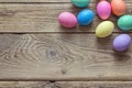 Colored Easter eggs on old wooden background.