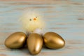 Easter eggs on wooden background next to basket with baby chicken Royalty Free Stock Photo