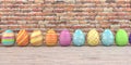 Colored easter eggs on the wooden table and brick wall in the background. Royalty Free Stock Photo