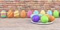 Colored easter eggs on the wooden table and brick wall in the background. Royalty Free Stock Photo