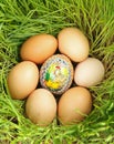 Colored egg between unpainted eggs