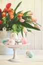 Colored eggs with bows with tulips