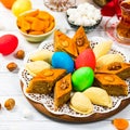 Colored eggs, wheat springs and sweet pastry for Nowruz Holiday in Azerbaijan on White Wooden Background Royalty Free Stock Photo