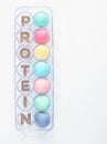 Colored Eggs with Word Protein on White