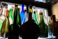 Colored empty bottles are on the windowsill Royalty Free Stock Photo