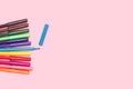 Colored felt tip pens, one open, on a pink background Royalty Free Stock Photo