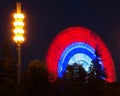 Colored Ferris wheel in summer night park