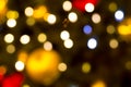 Colored festive lights spots on the background of a golden ball of blues, the basis of a Christmas