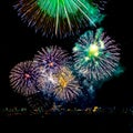 Colored fireworks display on dark sky background. Royalty Free Stock Photo