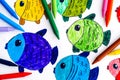 Colored fishes. Child hand drawing with colored crayons