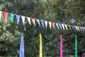 Colored flags hang on a rope in the park where the celebration takes place.