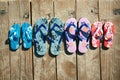 Colored flip-flops of a family of four by the beach at the ocean Royalty Free Stock Photo