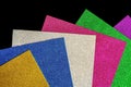 Colored foamiran sheets with sparkles on black background Royalty Free Stock Photo