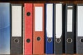 Colored folders for office files and paper on a shelf. Background image Royalty Free Stock Photo