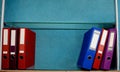 Colored Folders For Office Files And Paper On A Shelf.