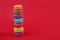 Colored macaroons on a red background
