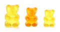 Colored fruit gummy candy in the form of a bear, white background.