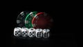 Colored gambling chips and white dice on a black background Royalty Free Stock Photo