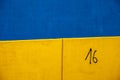 Colored and geometric concrete walls, blue, yellow and number 16. Details of concrete buildings