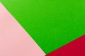 Colored geometric pink and green paper texture background.