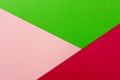 Colored geometric pink and green paper texture background.